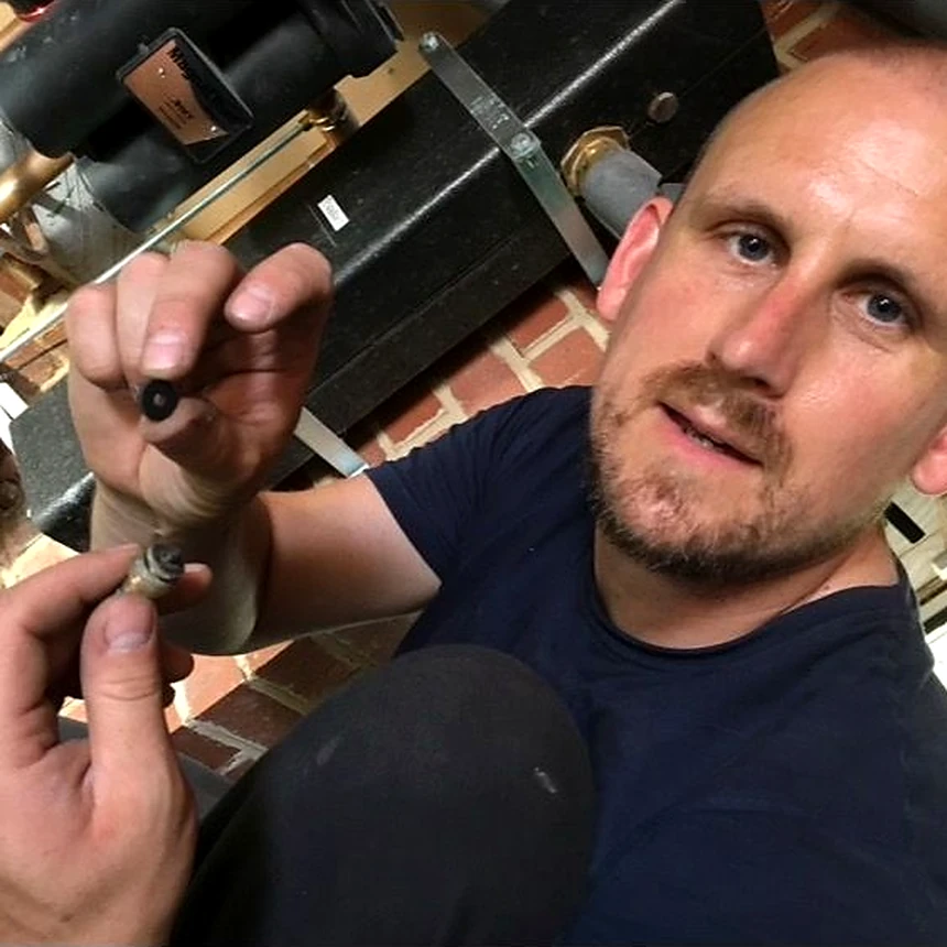 Dan Widger, owner of Aspie Plumbing & Heating Ltd, working on a pipe fitting