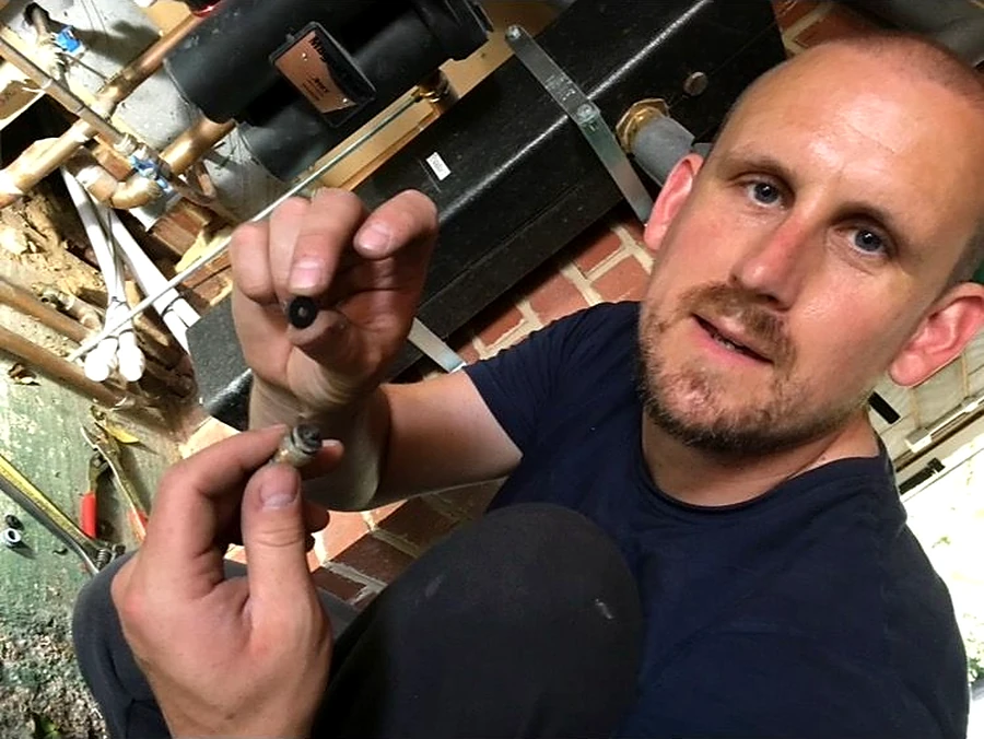 Dan Widger, owner of Aspie Plumbing & Heating Ltd, working on a heating system