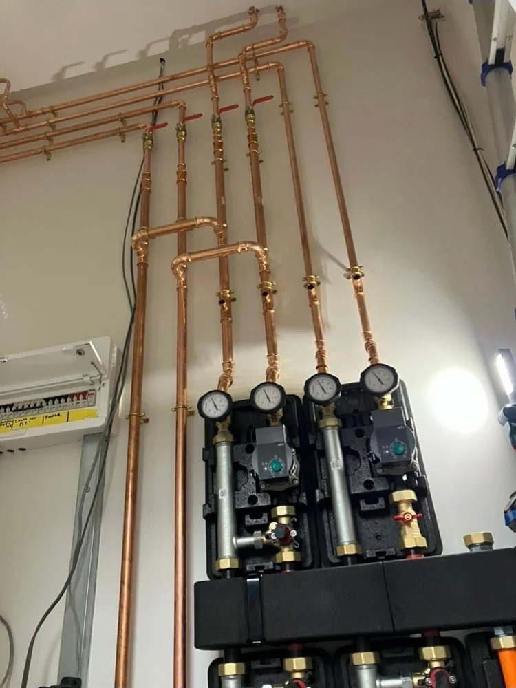Copper flow and return pipework running to the heating pump and mixing modules