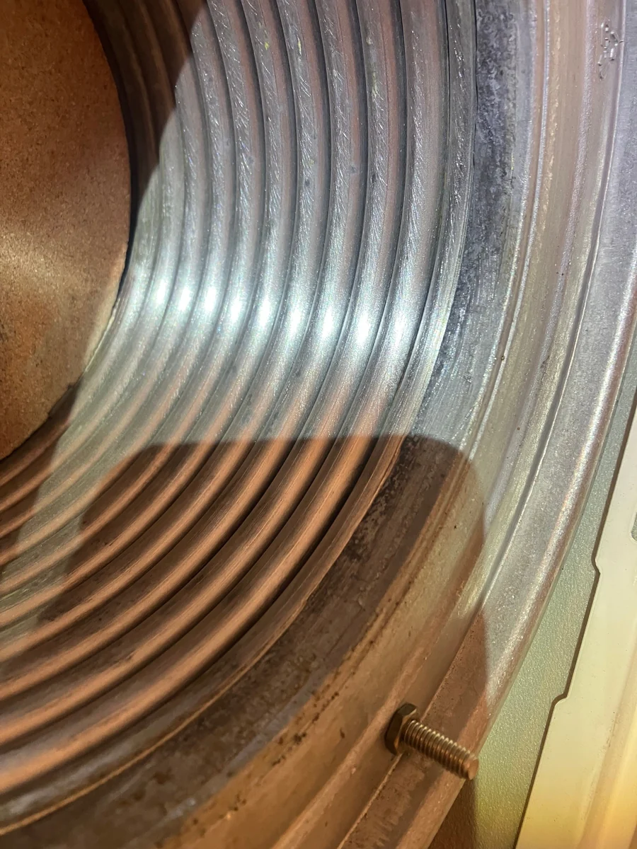Close-up of the heat exchanger fins being checked during a boiler service