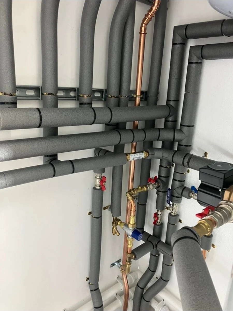 Insulated heating flow and return pipework with isolation valves in a plant room